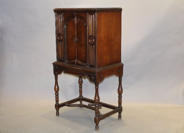 Antique wooden cabinet on decorative legs.