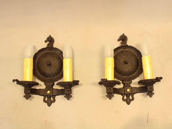 Antique wall sconces with candle bulbs.