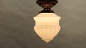 Vintage ceiling light with frosted glass shade.