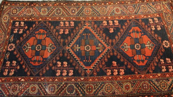 Geometric patterned Persian rug with vibrant colors.