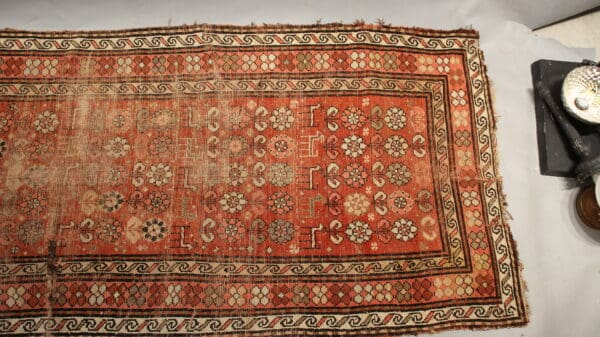 Antique red and gold patterned rug.