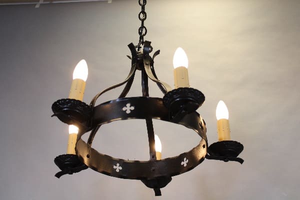 Vintage wrought iron chandelier with candles.