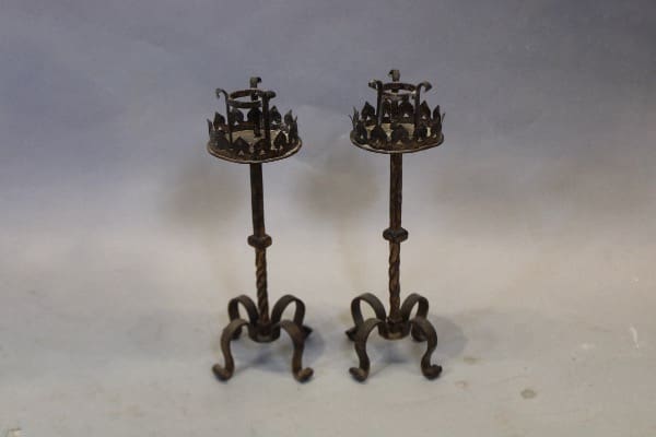 Two ornate metal candle holders with stands.