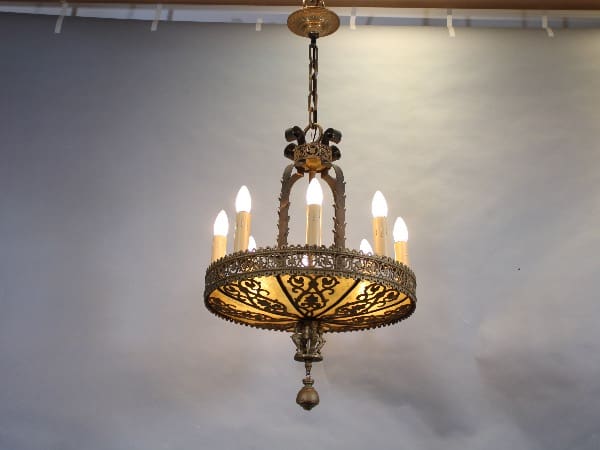 Antique chandelier with ornate metal design.