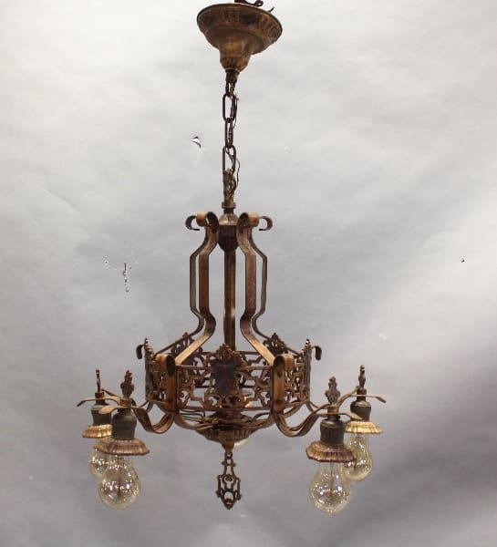 Vintage ornate chandelier with exposed bulbs.