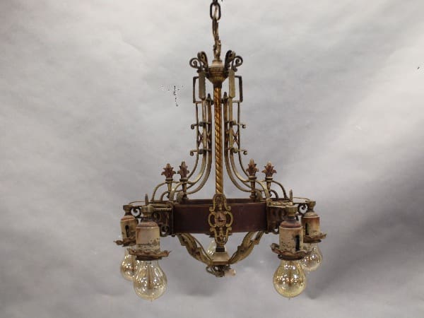 Antique bronze chandelier with four light bulbs.