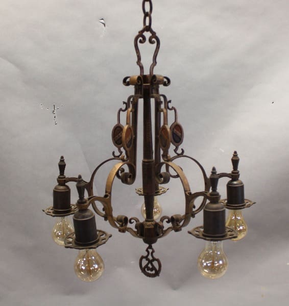 Vintage metal chandelier with exposed bulbs.
