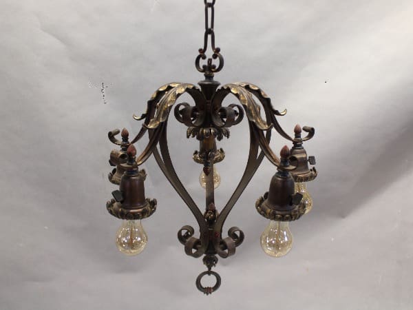 Ornate vintage chandelier with exposed bulbs.