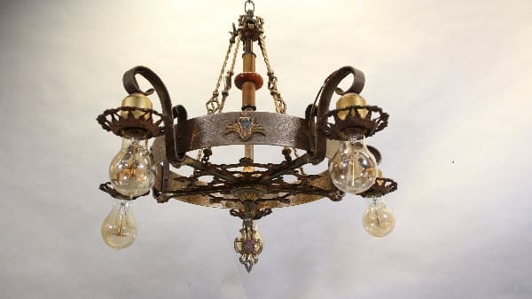 Vintage wrought iron chandelier with bulbs.