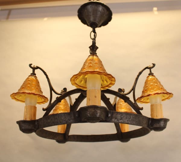 Vintage chandelier with orange glass shades.
