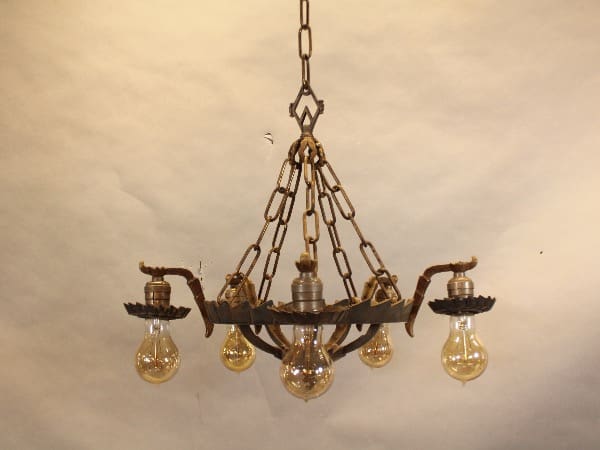 Vintage chandelier with exposed light bulbs.