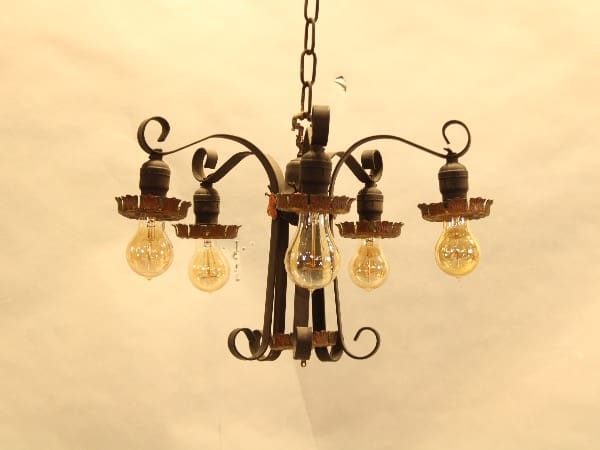 Vintage chandelier with exposed light bulbs.