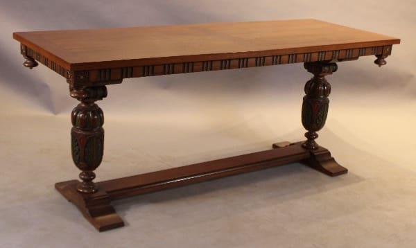 Wooden table with ornate carved legs.