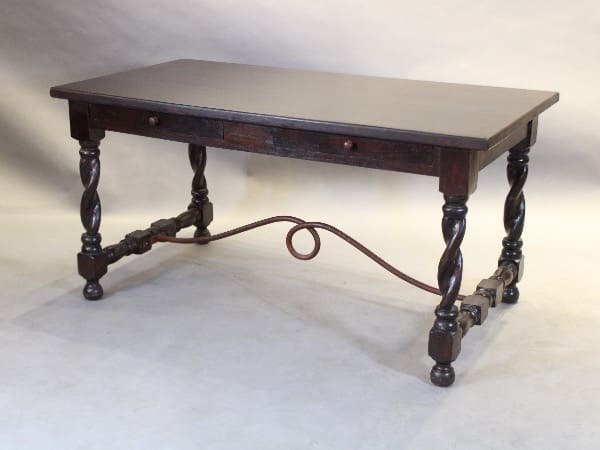 Antique wooden table with ornate legs.