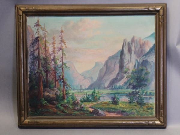 Framed landscape painting with mountains and trees.