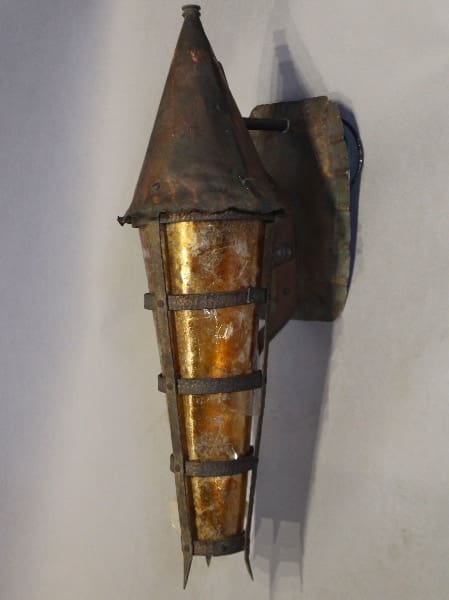 Rustic wall-mounted lantern with metal frame.