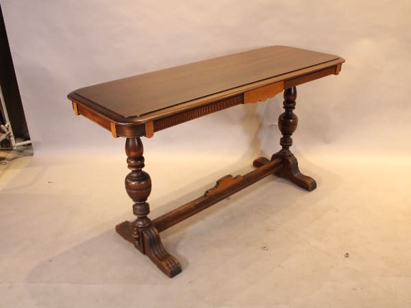 Antique wooden table with decorative legs.