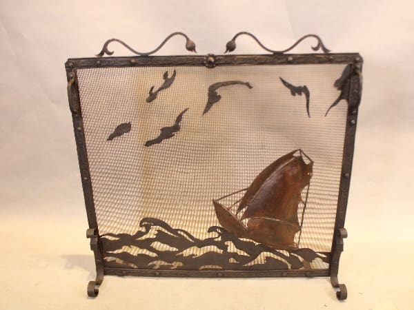 Decorative fire screen with ship and birds.