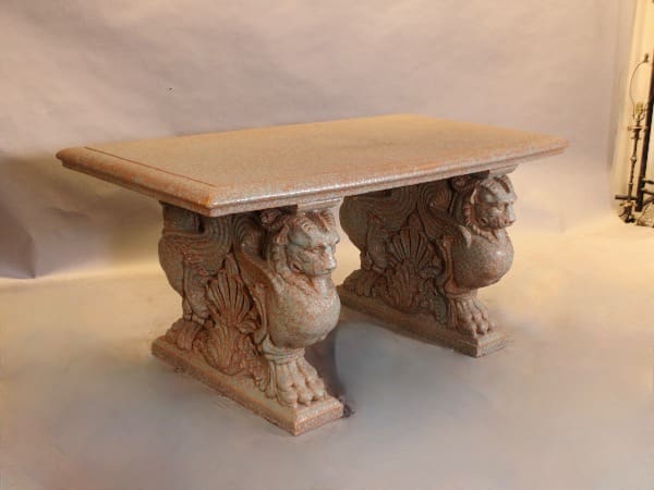 Stone table with ornate lion supports.