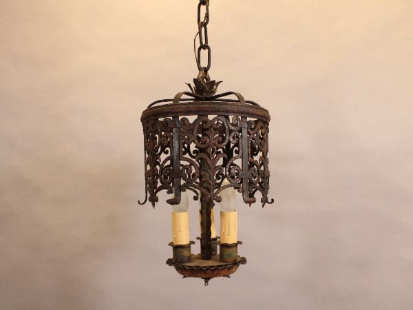 Ornate vintage wrought iron chandelier hanging.