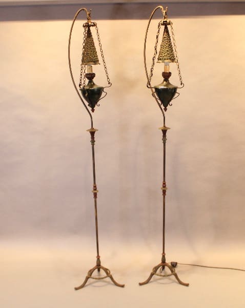Two ornate antique standing lamps with chains.