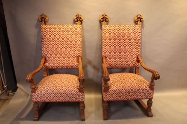Two ornate wooden chairs with patterned upholstery.
