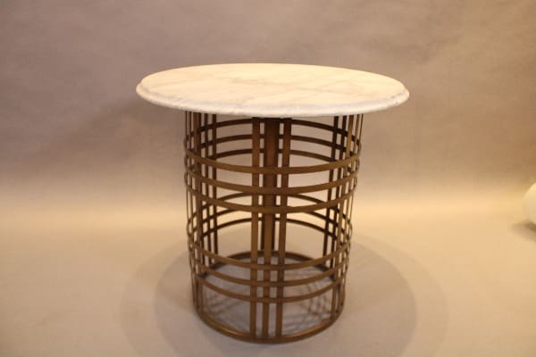 Round table with metal lattice base.