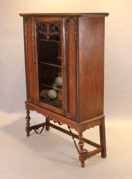 Antique wooden cabinet with glass door.
