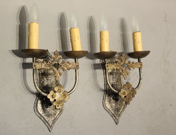 Vintage metal wall sconces with candles.