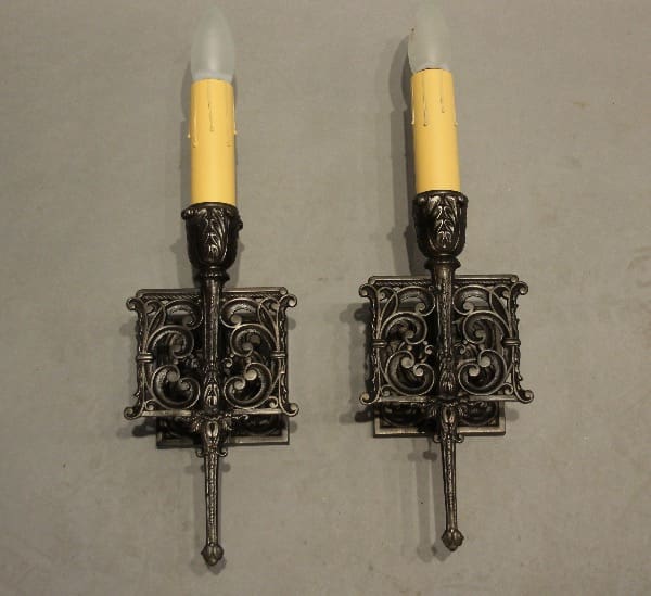 Two ornate wall-mounted candle sconces.