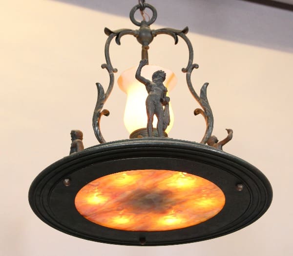 Vintage chandelier with intricate metalwork and lighting.