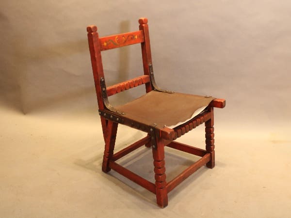 Wooden chair with leather seat.