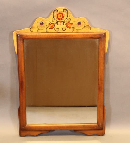 Ornate wooden mirror with floral design.