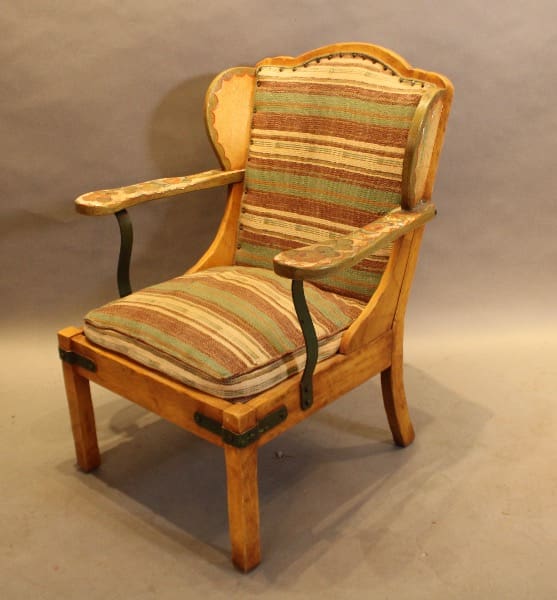 Vintage wooden chair with striped cushions.