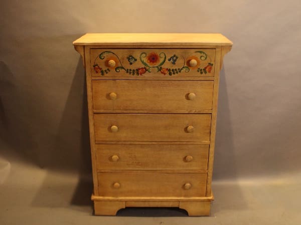 Wooden dresser with floral painted design.