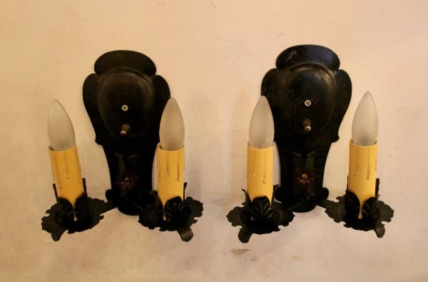 Vintage dual candle wall sconces on display.