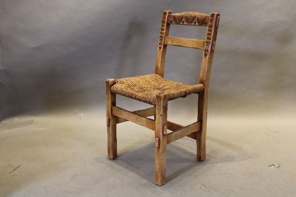 Wooden chair with woven seat.