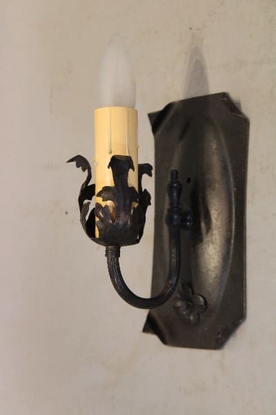 Vintage wall sconce with ornate design.