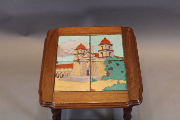 Wooden table with colorful tile artwork.