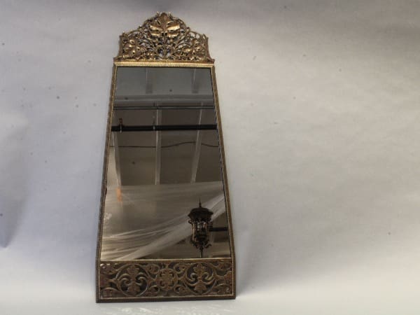 Ornate antique mirror with decorative frame.