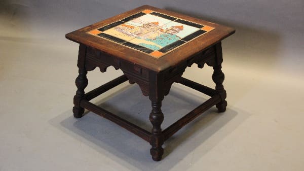 Wooden table with colorful mosaic top design.