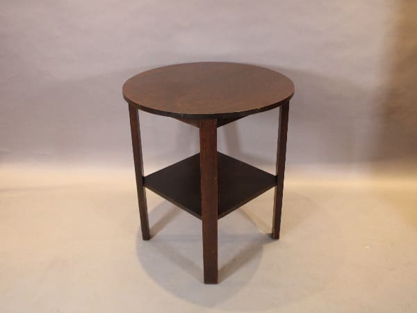 Round wooden side table with lower shelf.