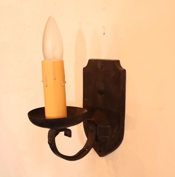 Wall-mounted vintage candle-style light fixture.