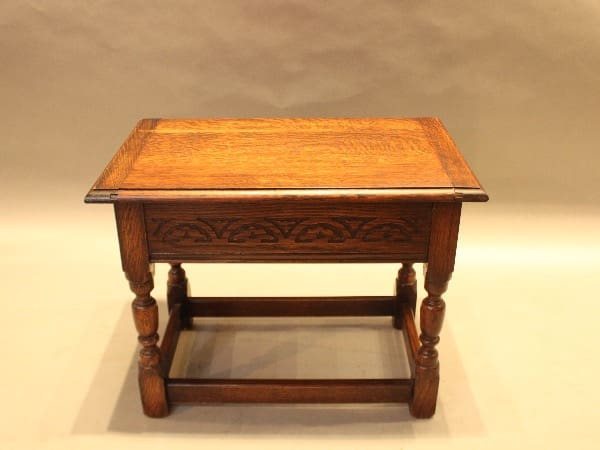 Wooden antique table with ornate carvings.