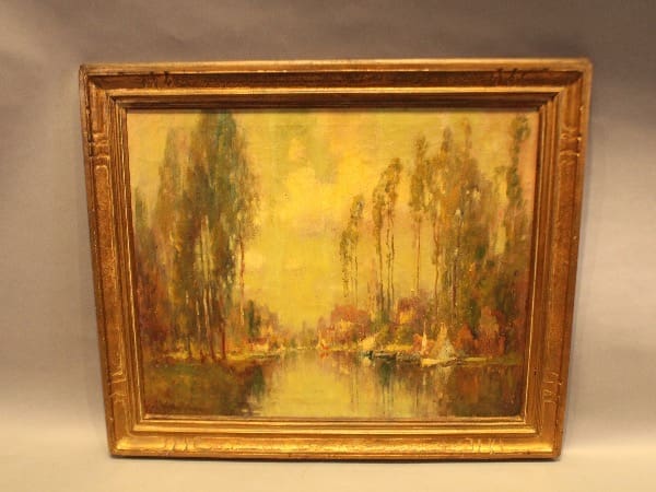 Framed landscape painting with trees and river.