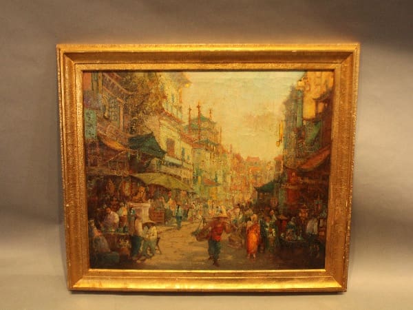 Framed painting of a bustling street scene.
