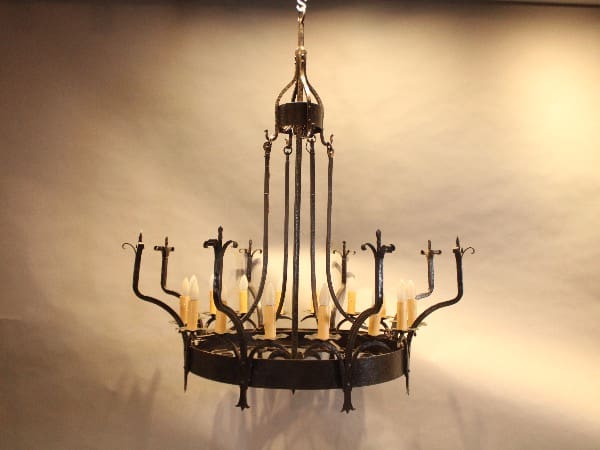 Iron chandelier with candle-style lights.
