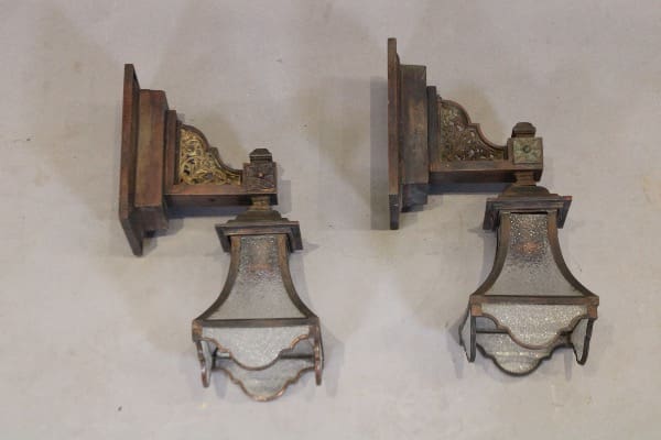 Two vintage wall-mounted lanterns on display.