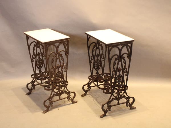 Two ornate wrought iron side tables.