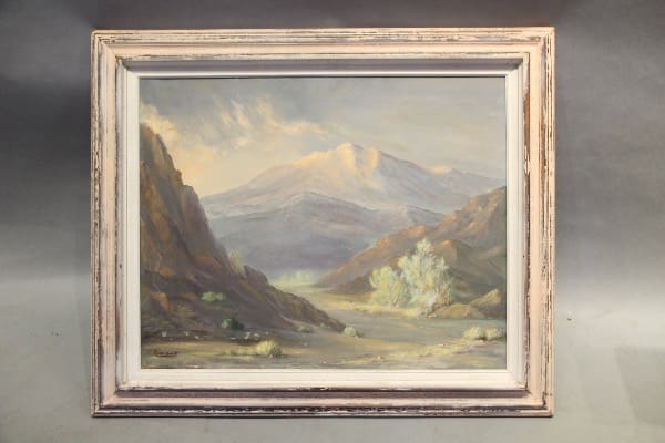 Framed landscape painting with mountains and valley.